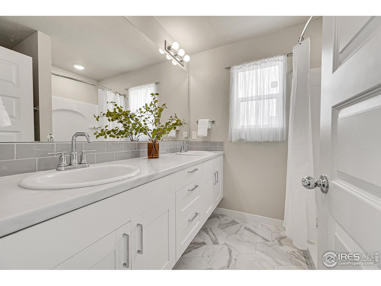 403 Pony Express Trail Ault, CO 80610 - Photo 17 of 31 a bathroom with a sink double vanity and a mirror