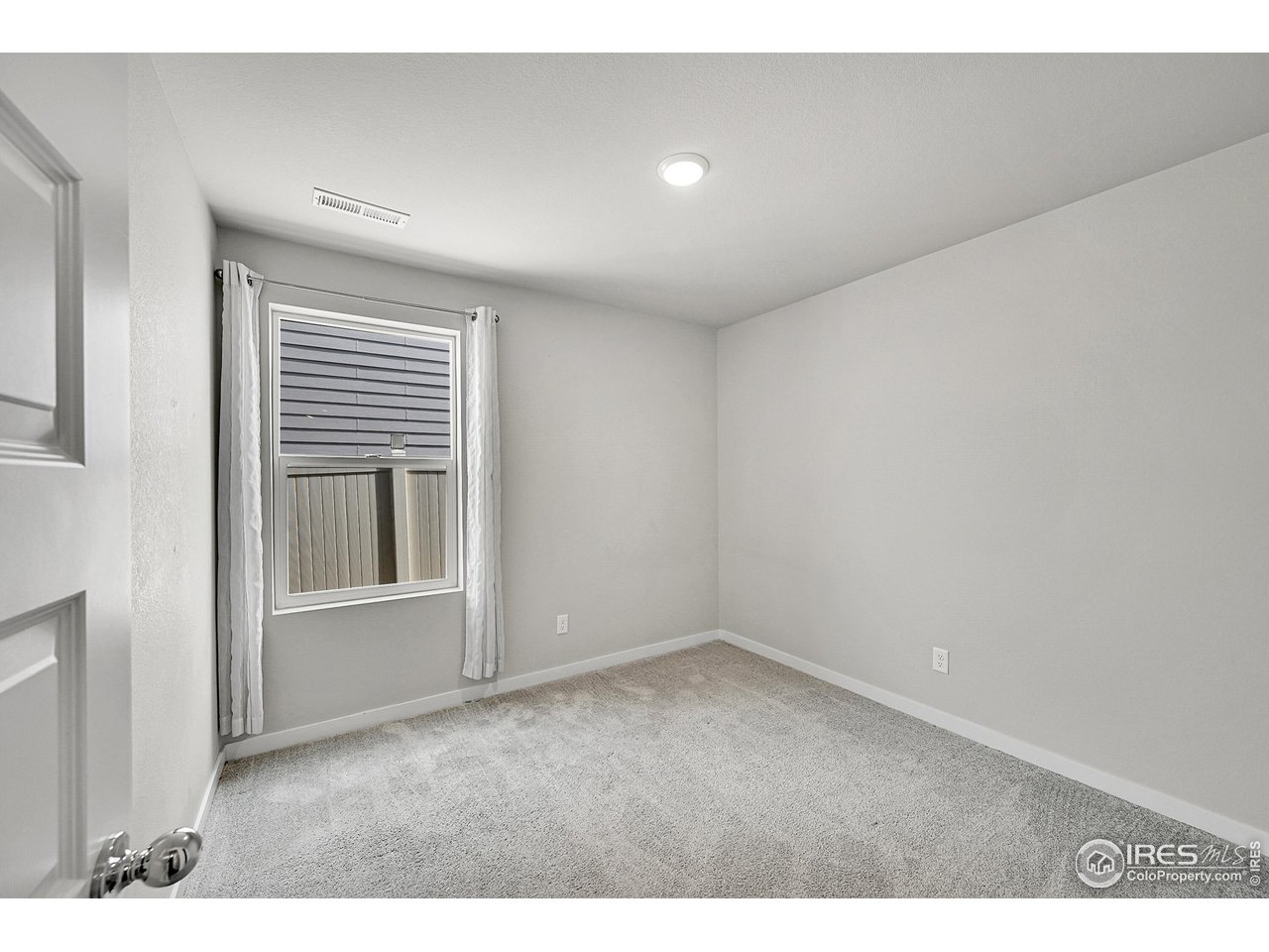 403 Pony Express Trail Ault, CO 80610 - Photo 20 of 31 a view of an empty room with a window