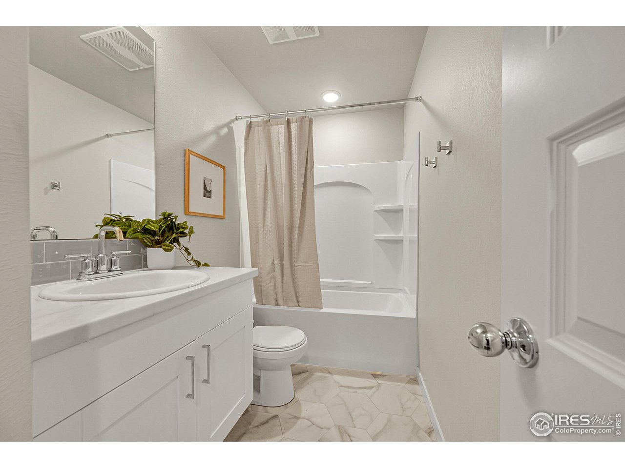 403 Pony Express Trail Ault, CO 80610 - Photo 21 of 31 a bathroom with a sink a toilet and a tub