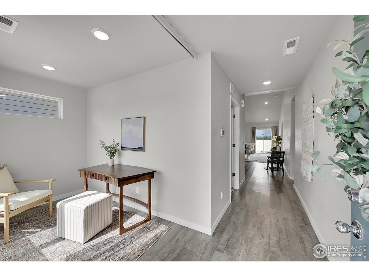 403 Pony Express Trail Ault, CO 80610 - Photo 5 of 31 a living room with furniture and a wooden floor
