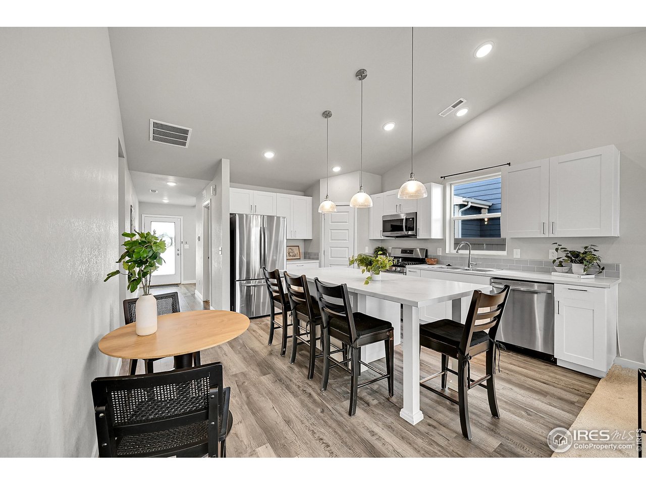 403 Pony Express Trail Ault, CO 80610 - Photo 7 of 31 a dining area with a table chairs and a kitchen view