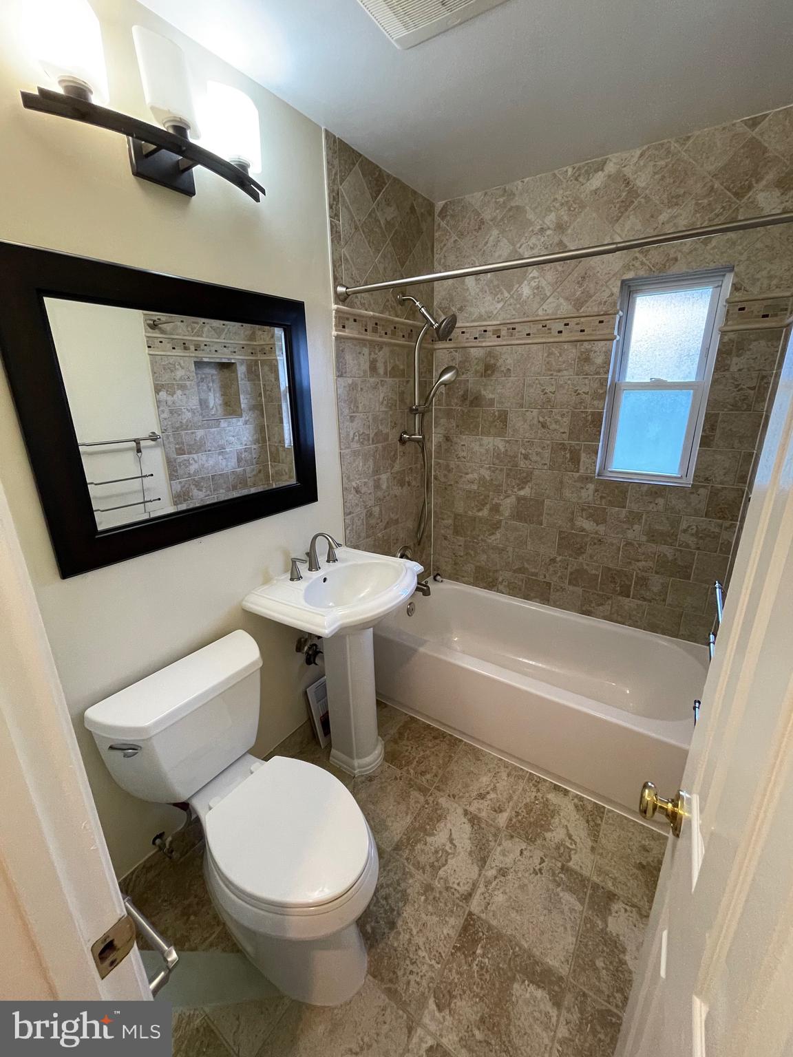7406 Kelvin Place Springfield, VA 22151 - Photo 12 of 16 a bathroom with a sink toilet and bathtub