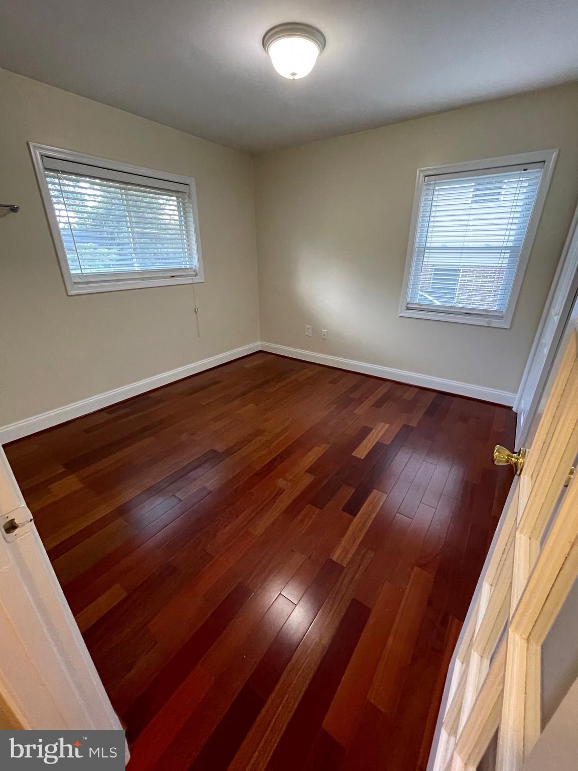 7406 Kelvin Place Springfield, VA 22151 - Photo 13 of 16 a view of an empty room with wooden floor and a window