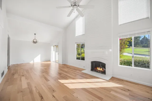a view of empty room with fireplace and window