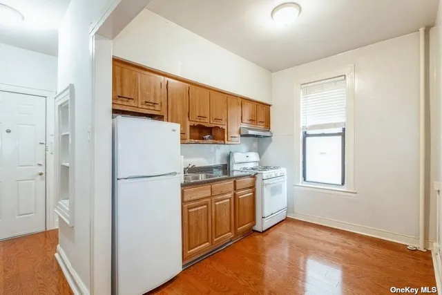 a kitchen with stainless steel appliances granite countertop a refrigerator sink and stove
