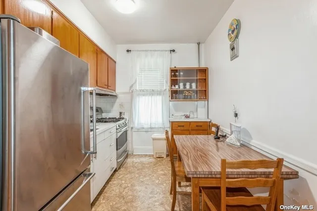 a kitchen with stainless steel appliances granite countertop a refrigerator and a stove top oven