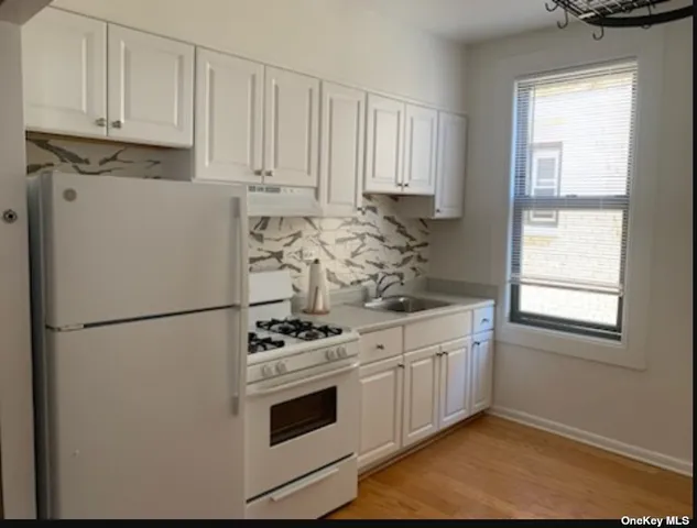 a white refrigerator freezer sitting inside of a kitchen