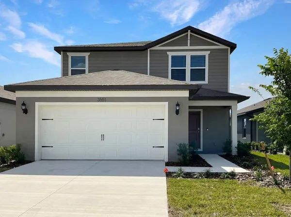 a front view of a house with garage