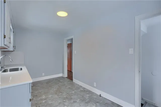 a view of a storage and utility room with a sink