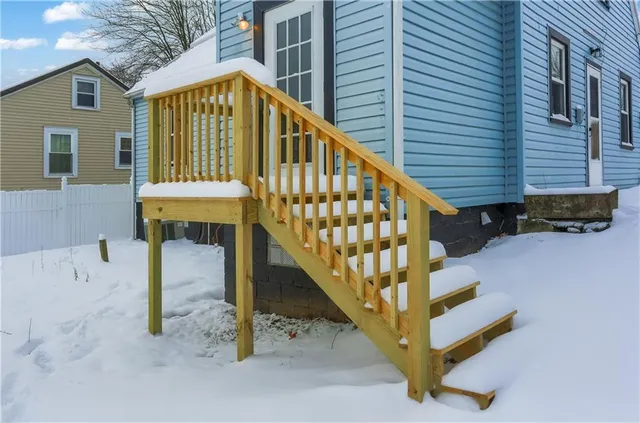 a view of staircase with railing and white walls