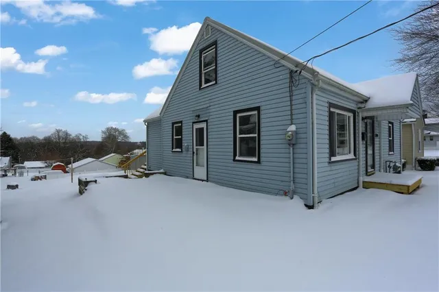 a view of a house with a yard and sitting area