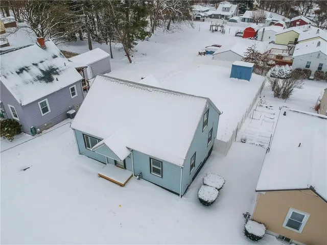 a dirty bathroom with a bathtub and covered with snow