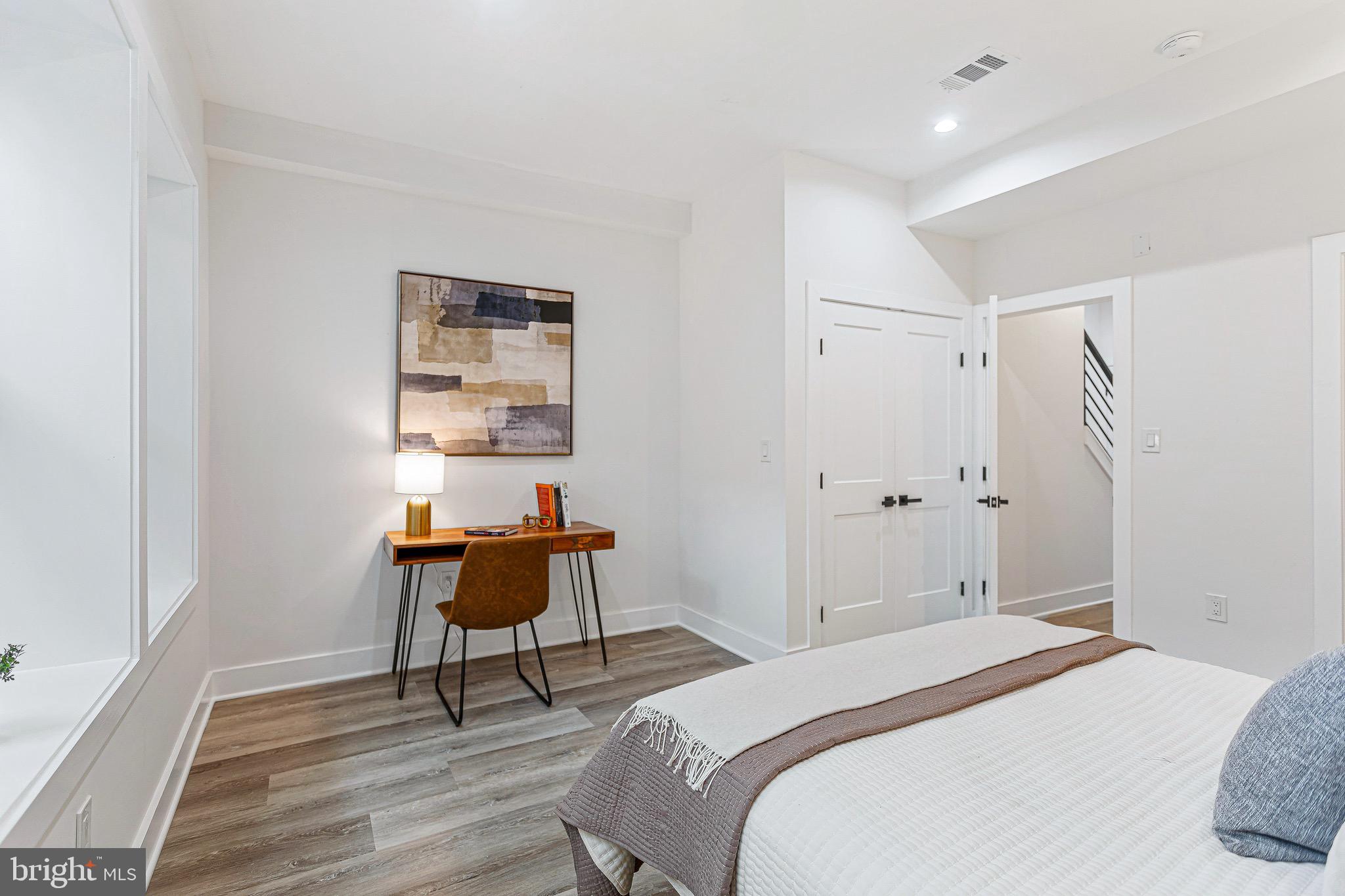 1107 Queen Street Northeast, Unit 2 Washington, DC 20002 - Photo 11 of 26 a bedroom with a bed and a table in it