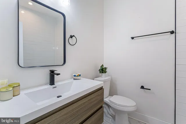 a bathroom with a sink toilet and mirror