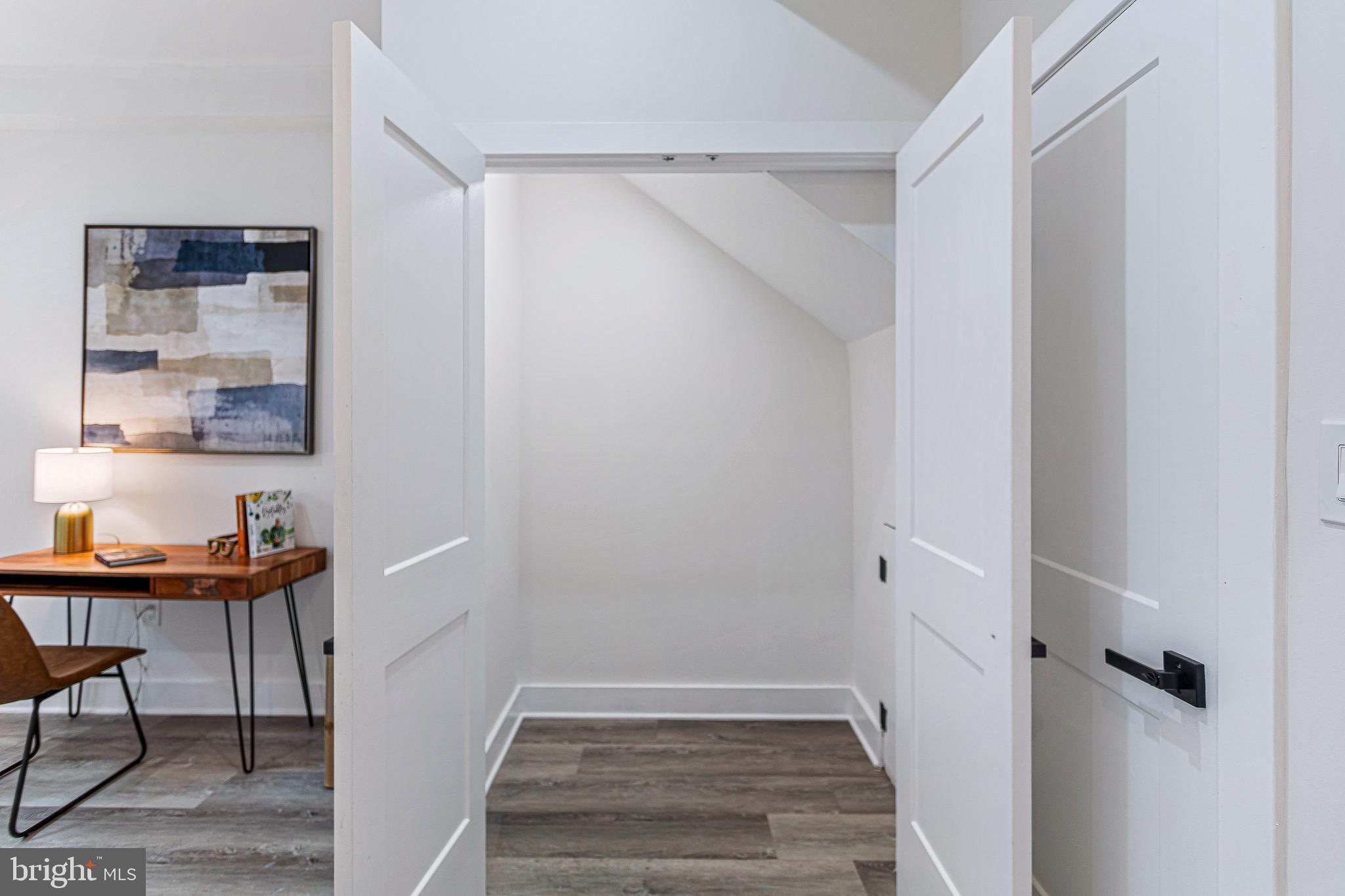 1107 Queen Street Northeast, Unit 2 Washington, DC 20002 - Photo 14 of 26 a view of a hallway to a livingroom with furniture and wooden floor