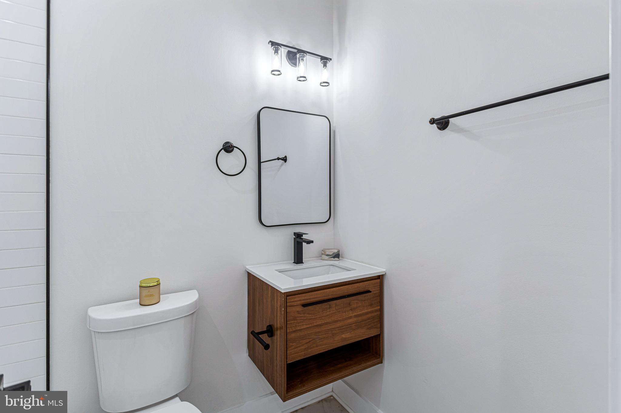 1107 Queen Street Northeast, Unit 2 Washington, DC 20002 - Photo 18 of 26 a bathroom with a sink toilet and mirror