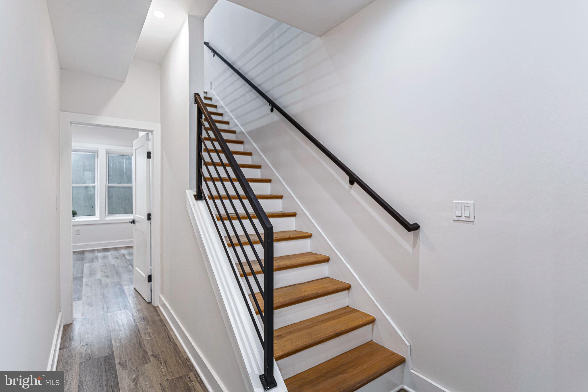 1107 Queen Street Northeast, Unit 2 Washington, DC 20002 - Photo 9 of 26 a view of staircase with wooden floor and white walls
