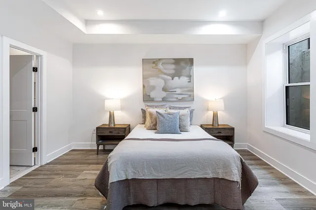 a bedroom with a bed and a night stand