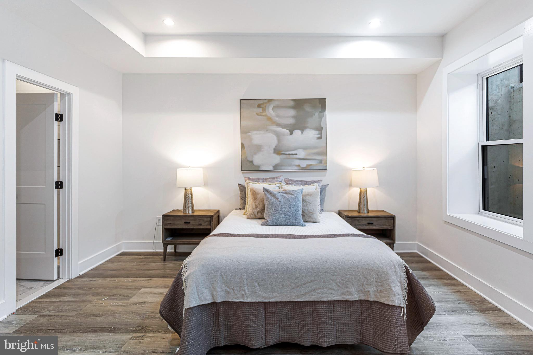 1107 Queen Street Northeast, Unit 2 Washington, DC 20002 - Photo 10 of 26 a bedroom with a bed and a night stand