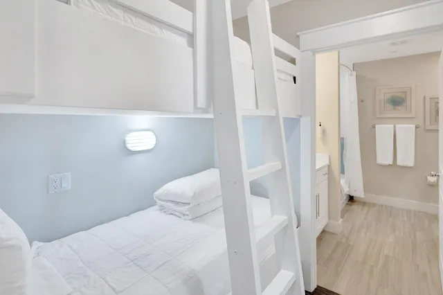 a bedroom with a bed and a table chair