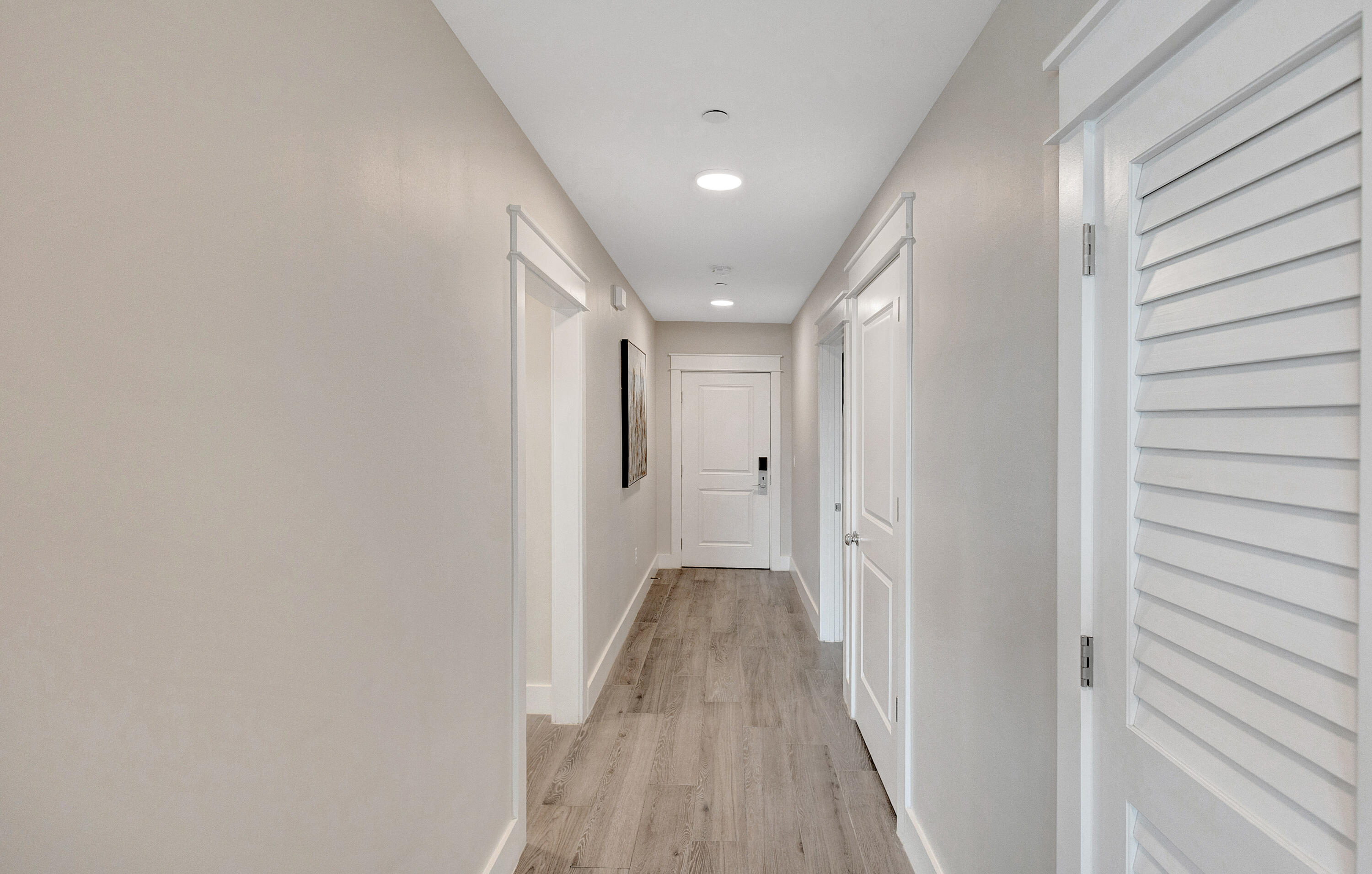 204 Henderson Resort Way, Unit 3104 Destin, FL 32541 - Photo 22 of 37 a view of a hallway with wooden floor