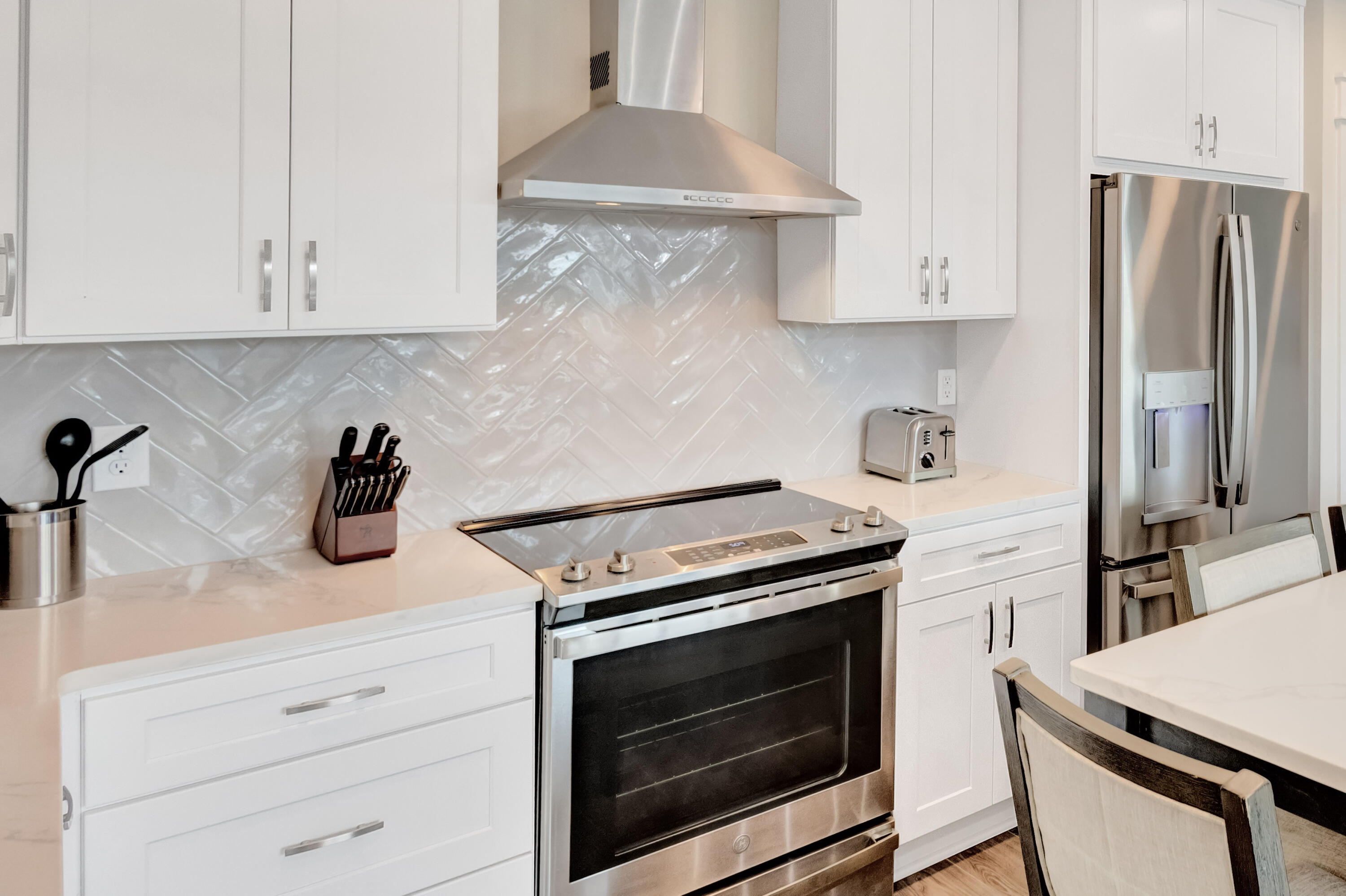 204 Henderson Resort Way, Unit 3104 Destin, FL 32541 - Photo 9 of 37 a kitchen with granite countertop white cabinets and white appliances