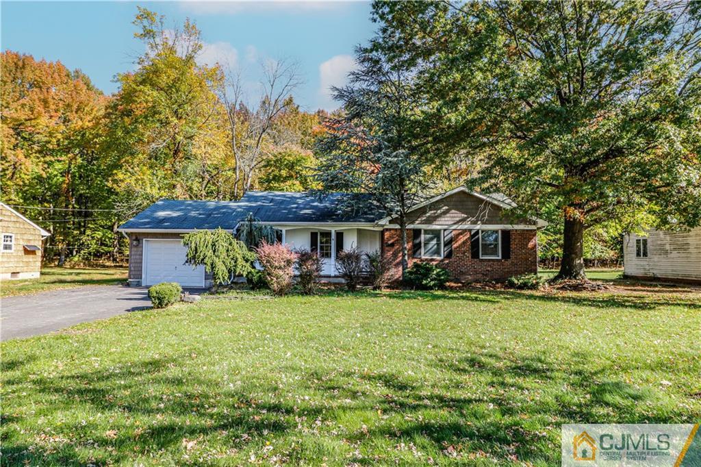 a view of a house with garden and trees