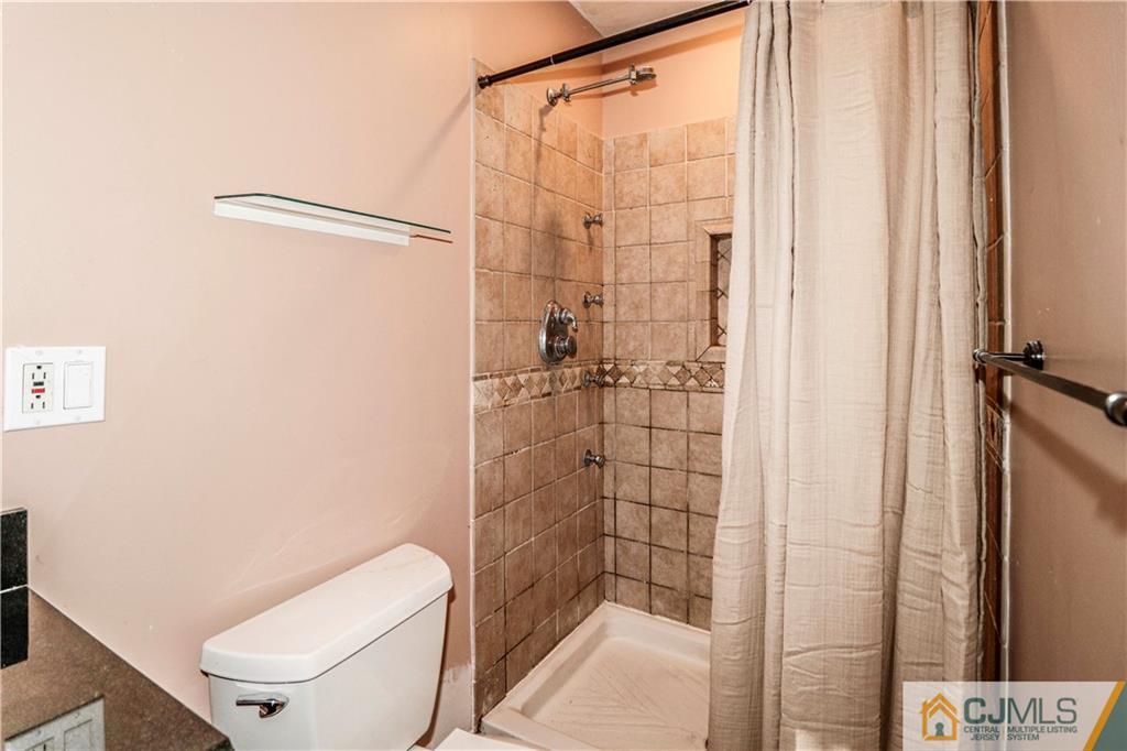 860 Grove Avenue Edison, NJ 08820 - Photo 16 of 22 a bathroom with a shower a toilet and a shower