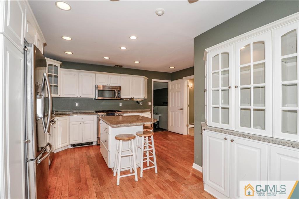 860 Grove Avenue Edison, NJ 08820 - Photo 4 of 22 a kitchen with a refrigerator and a stove top oven