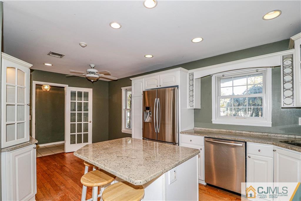 860 Grove Avenue Edison, NJ 08820 - Photo 5 of 22 a open kitchen with kitchen island a sink granite counter tops and a window