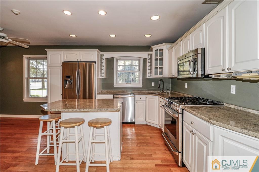 860 Grove Avenue Edison, NJ 08820 - Photo 6 of 22 a kitchen with stainless steel appliances granite countertop a stove a sink and a refrigerator