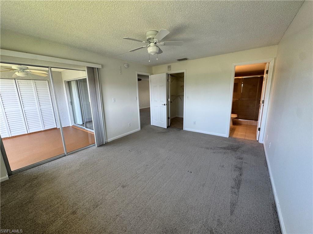 5667 Rattlesnake Hamm Road North, Unit B301 Naples, FL 34113 - Photo 10 of 17 an empty room with closet and fan