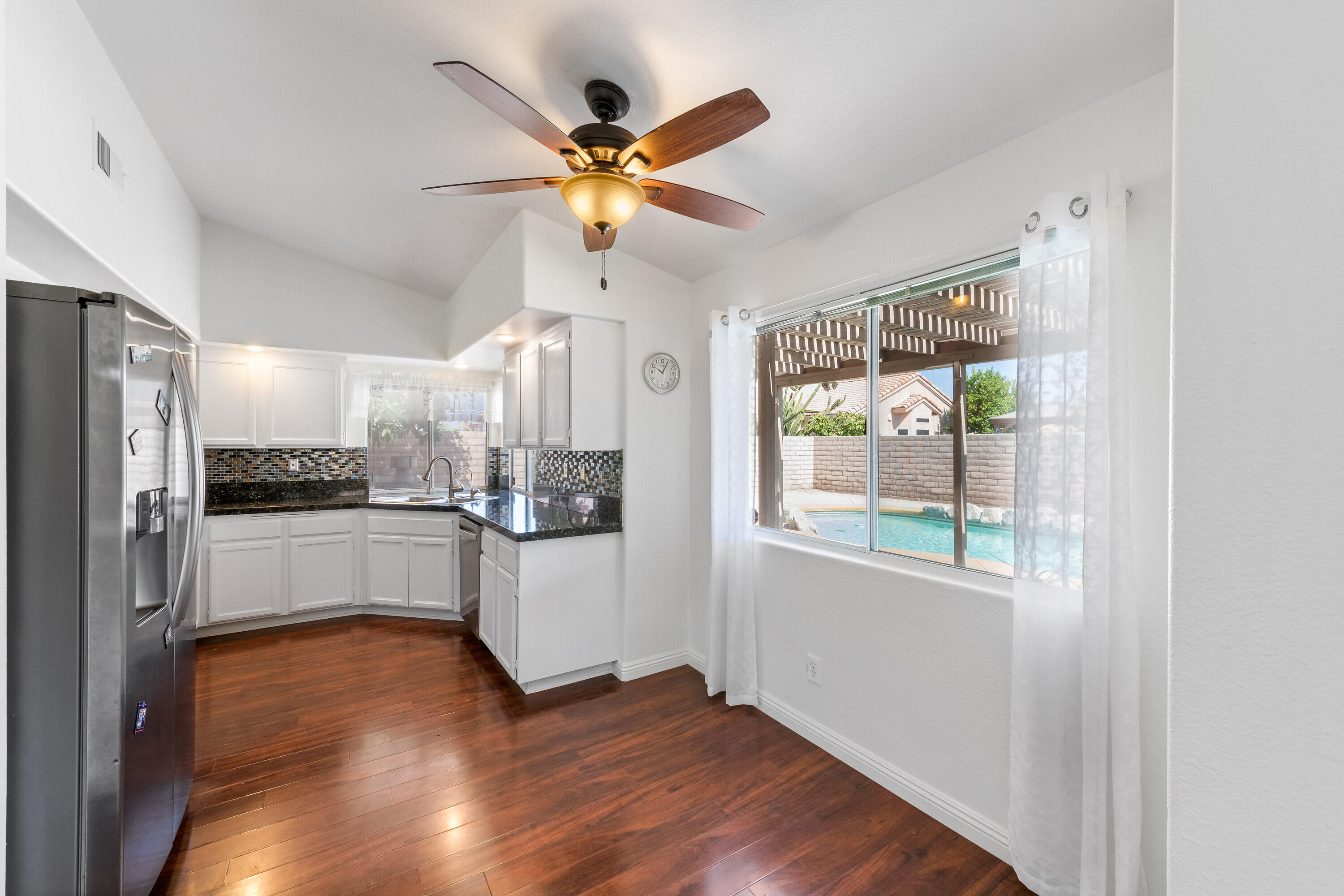 80366 Paseo Encanto Indio, CA 92201 - Photo 17 of 48 a kitchen with a refrigerator and white cabinets