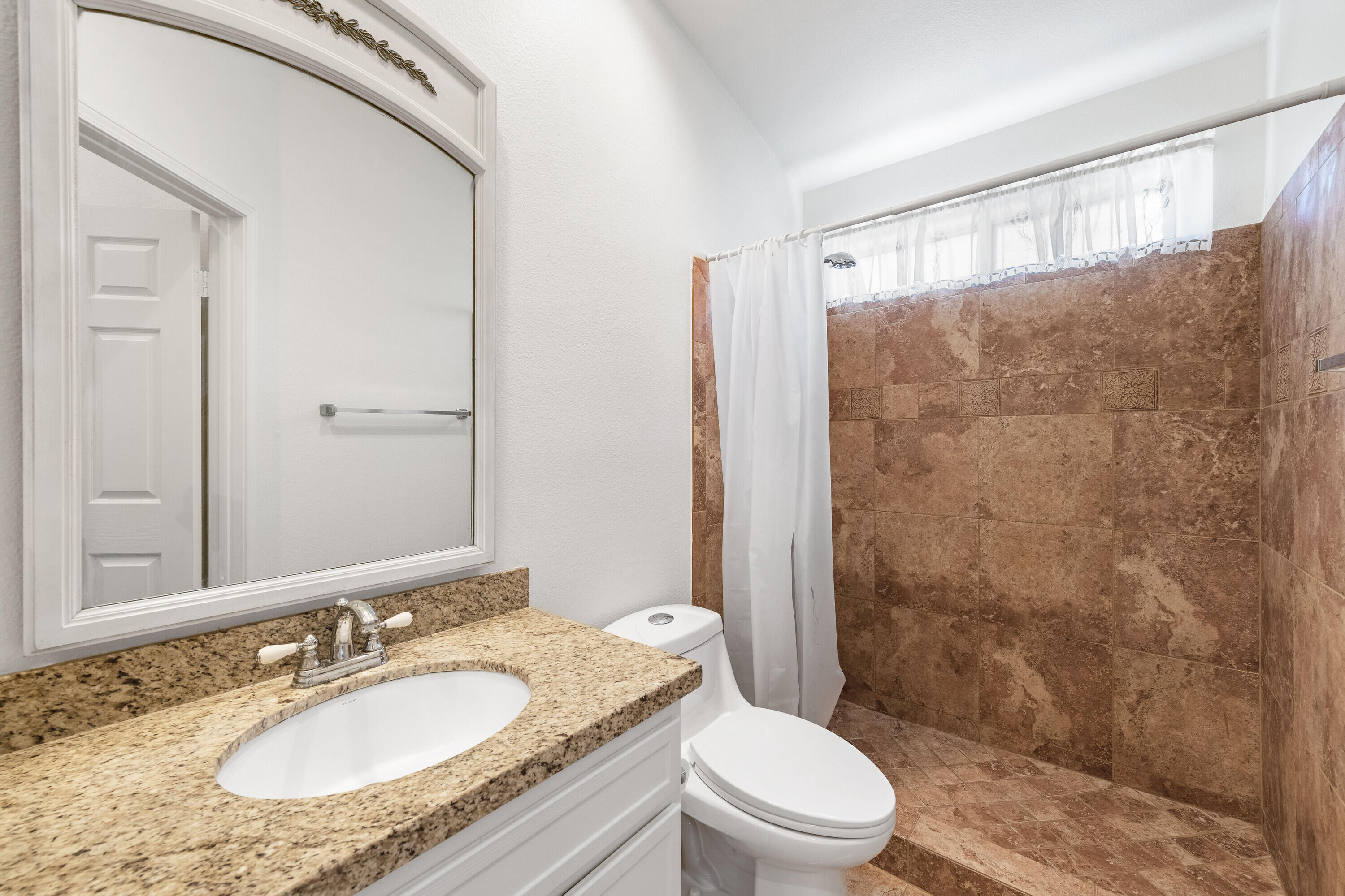 80366 Paseo Encanto Indio, CA 92201 - Photo 22 of 48 a bathroom with a granite countertop sink toilet a mirror and shower
