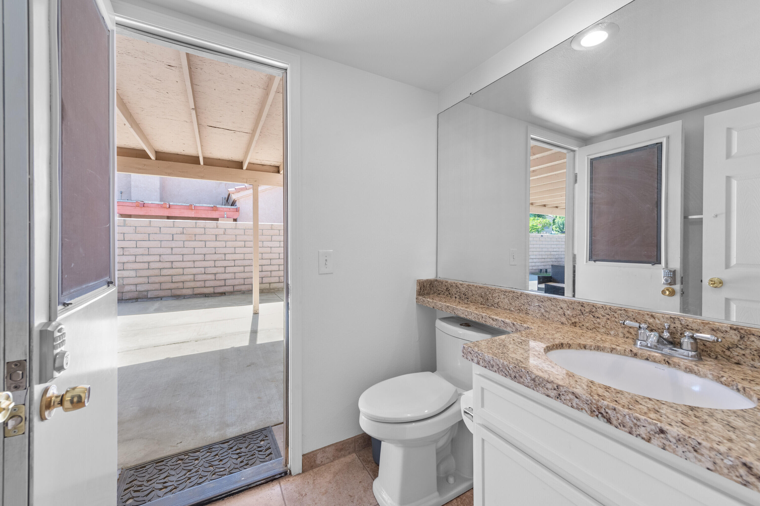 80366 Paseo Encanto Indio, CA 92201 - Photo 27 of 48 a bathroom with a granite countertop sink a toilet and shower