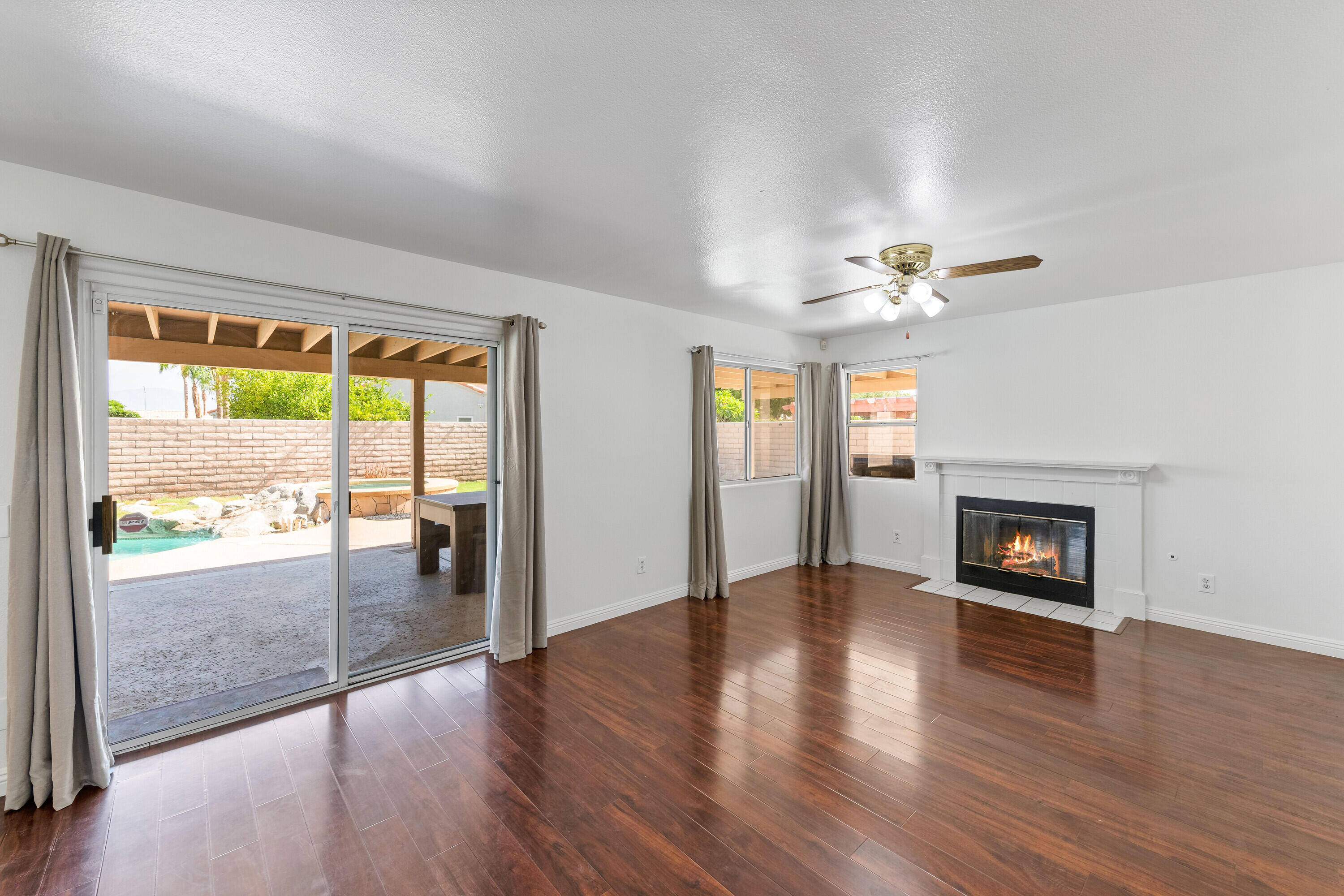 80366 Paseo Encanto Indio, CA 92201 - Photo 7 of 48 an empty room with wooden floor fireplace and windows