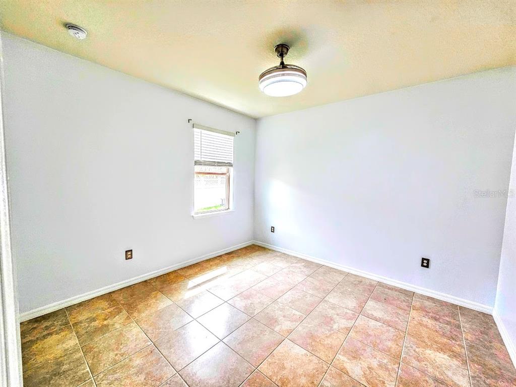 8594 Rindge Road Polk City, FL 33868 - Photo 11 of 16 a view of room with window and ceiling fan