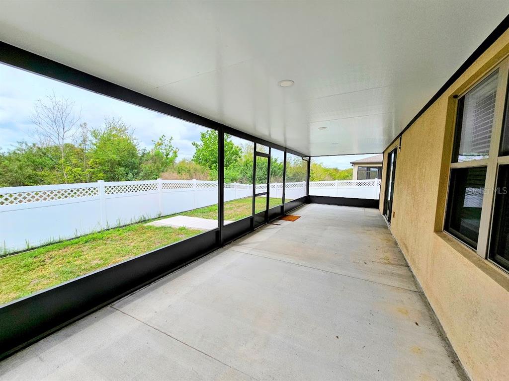 8594 Rindge Road Polk City, FL 33868 - Photo 16 of 16 a view of an empty room with wooden floor and windows