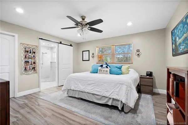 a bedroom with baby bed and a window