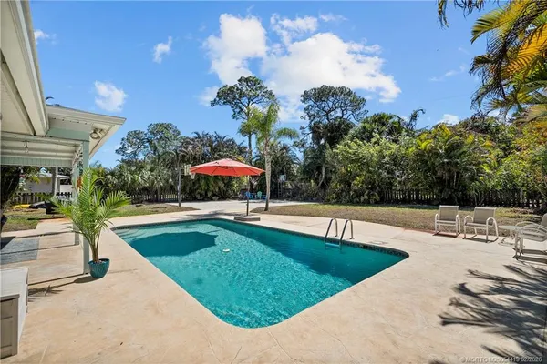 a view of a house with swimming pool and sitting area