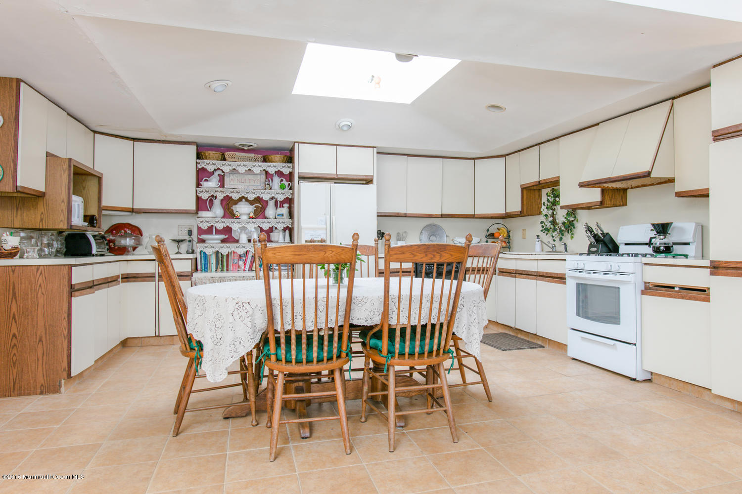 104 Meadowbrook Road Spring Lake Heights, NJ 07762 - Photo 13 of 22 a dining room with stainless steel appliances a table chairs and a refrigerator