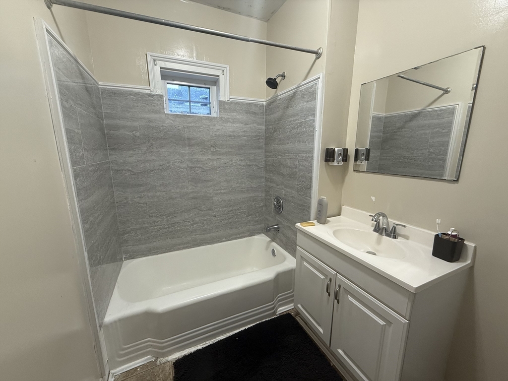 32 Manchester Street, Unit 1 Lowell, MA 01852 - Photo 6 of 8 a bathroom with a sink and a bathtub
