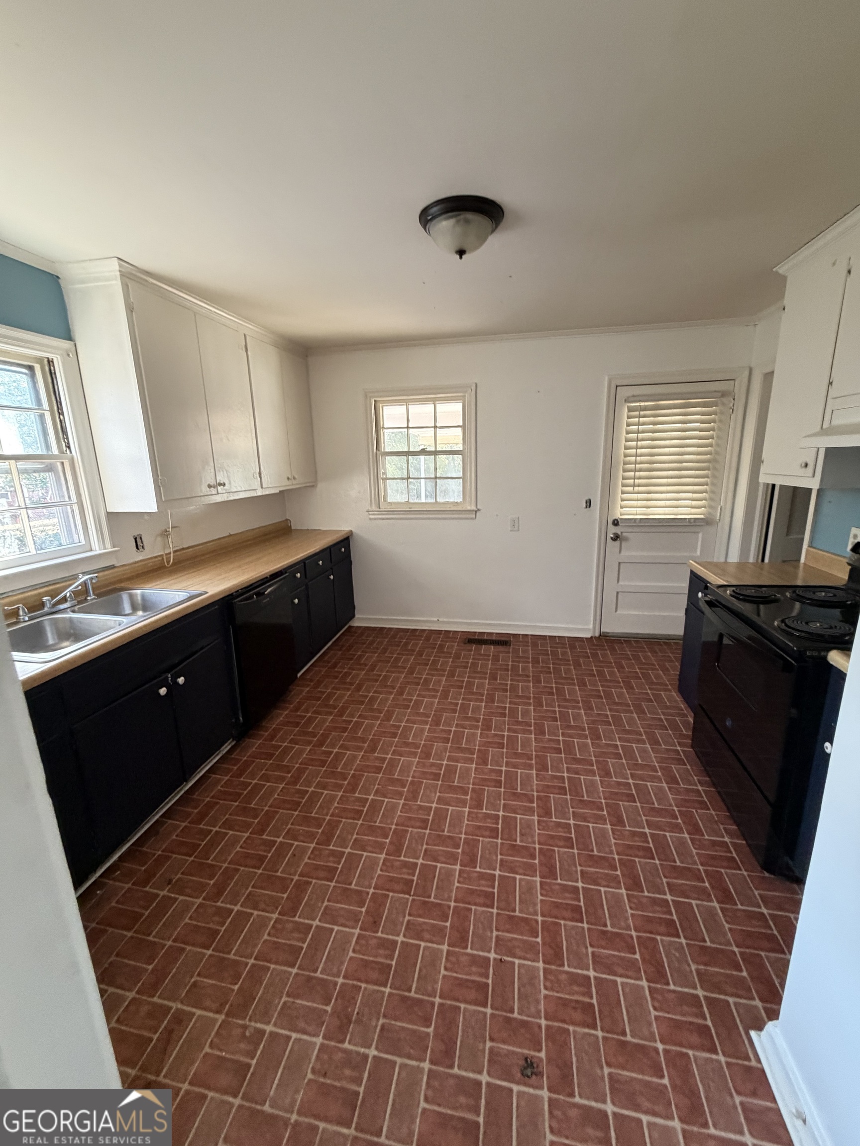 2006 Stonewall Street Dublin, GA 31021 - Photo 7 of 12 a room with a sink a window and cabinets