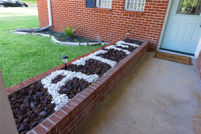 a side of a street with a garden