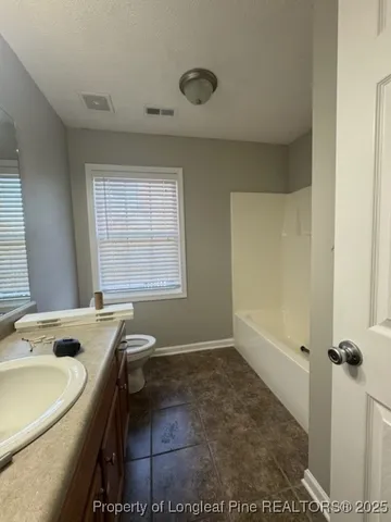 a bathroom with a tub sink and window