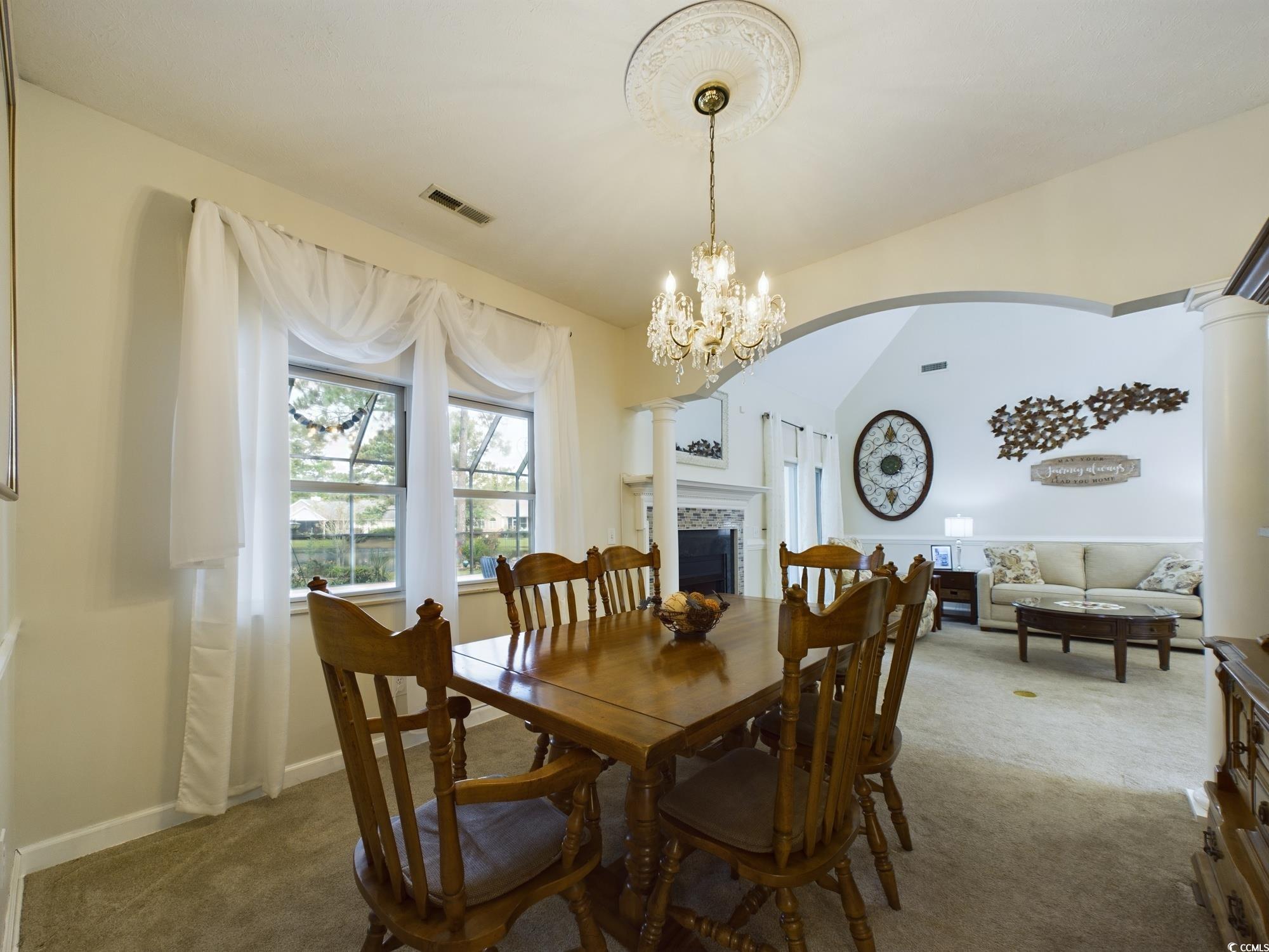 526 Saluda River Road Myrtle Beach, SC 29588 - Photo 24 of 40 Carpeted dining room featuring a notable chandelie