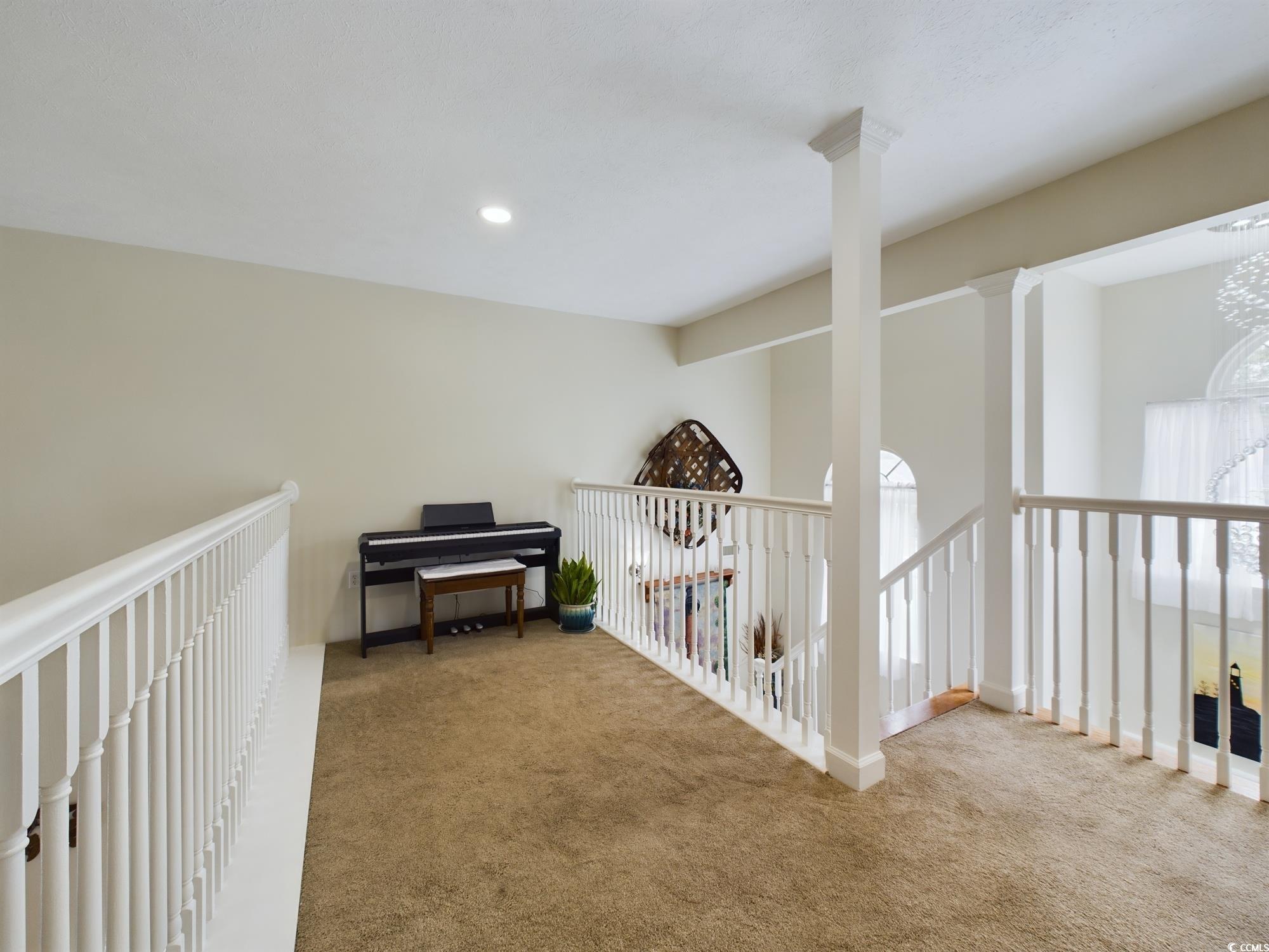 526 Saluda River Road Myrtle Beach, SC 29588 - Photo 32 of 40 Corridor featuring carpet, decorative columns, and