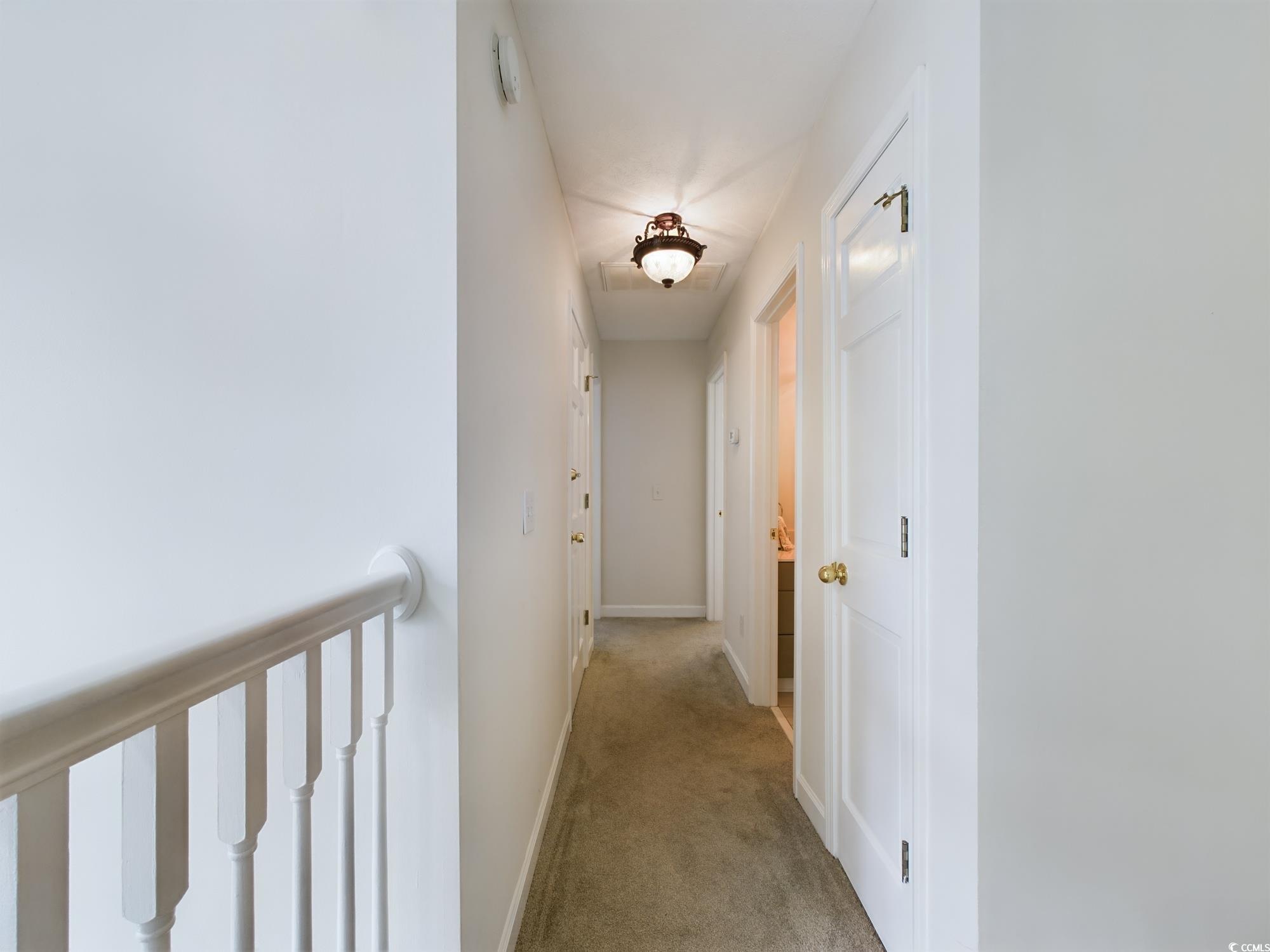 526 Saluda River Road Myrtle Beach, SC 29588 - Photo 33 of 40 Corridor featuring light colored carpet