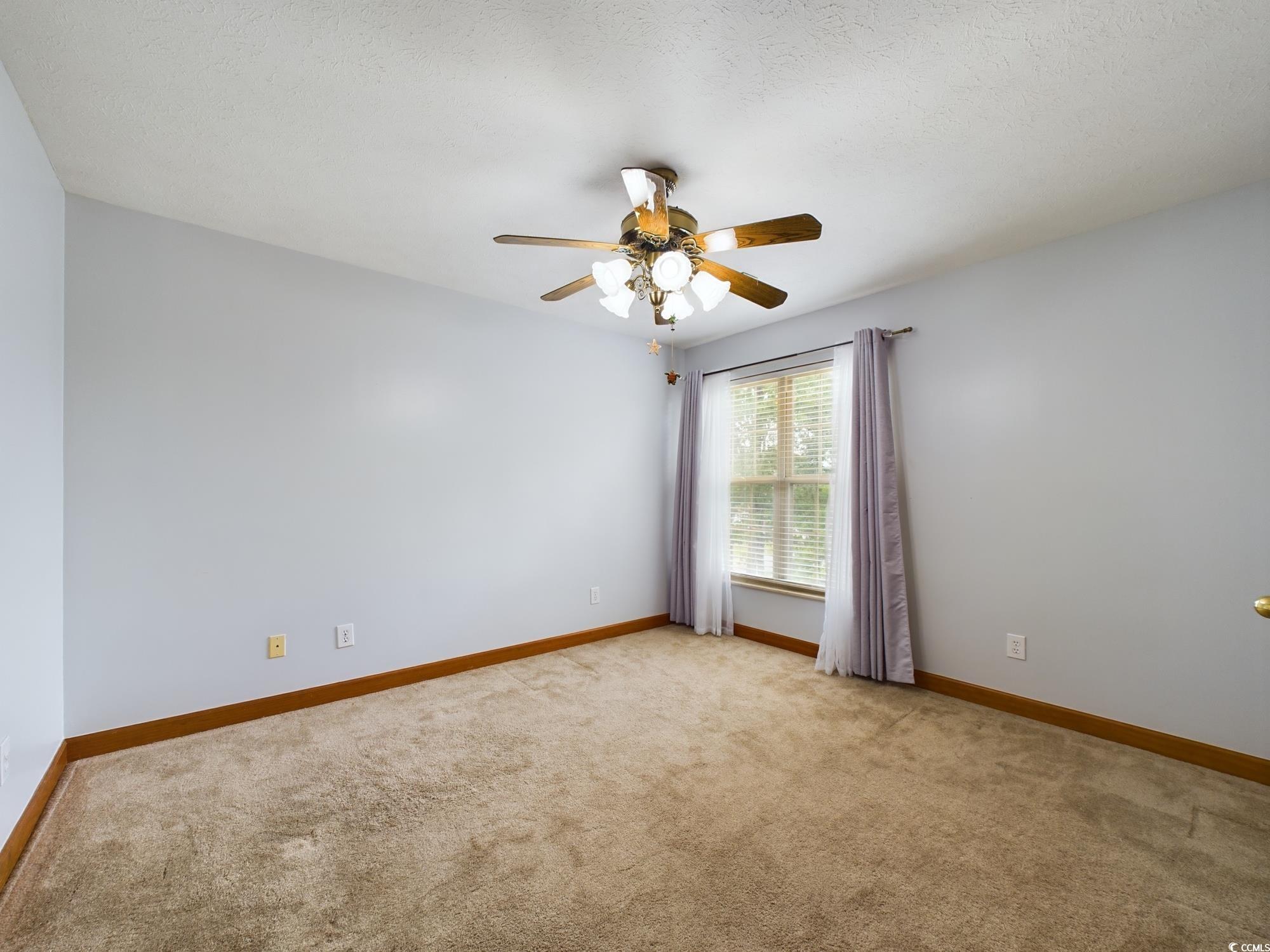 526 Saluda River Road Myrtle Beach, SC 29588 - Photo 35 of 40 Carpeted empty room featuring ceiling fan and a te