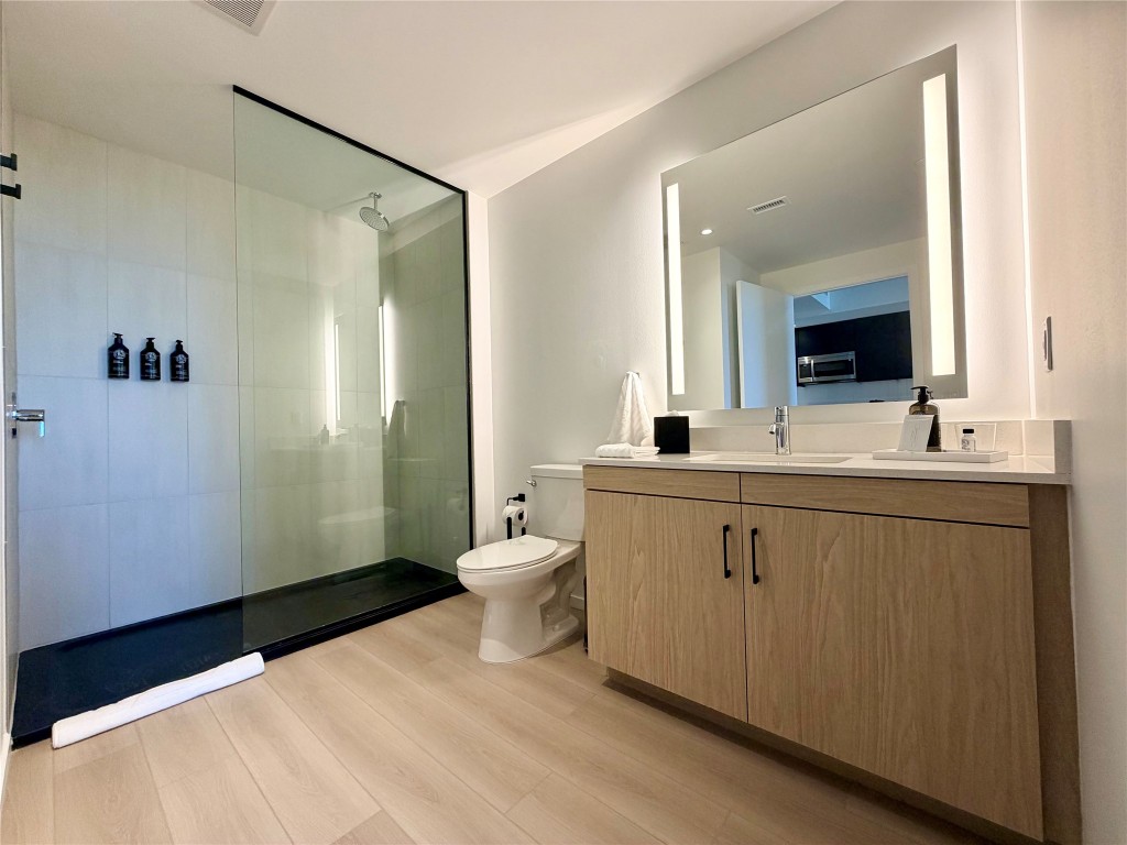 5501 La Branch Street, Unit 2108 Houston, TX 77004 - Photo 2 of 12 a bathroom with a double vanity sink toilet and mirror